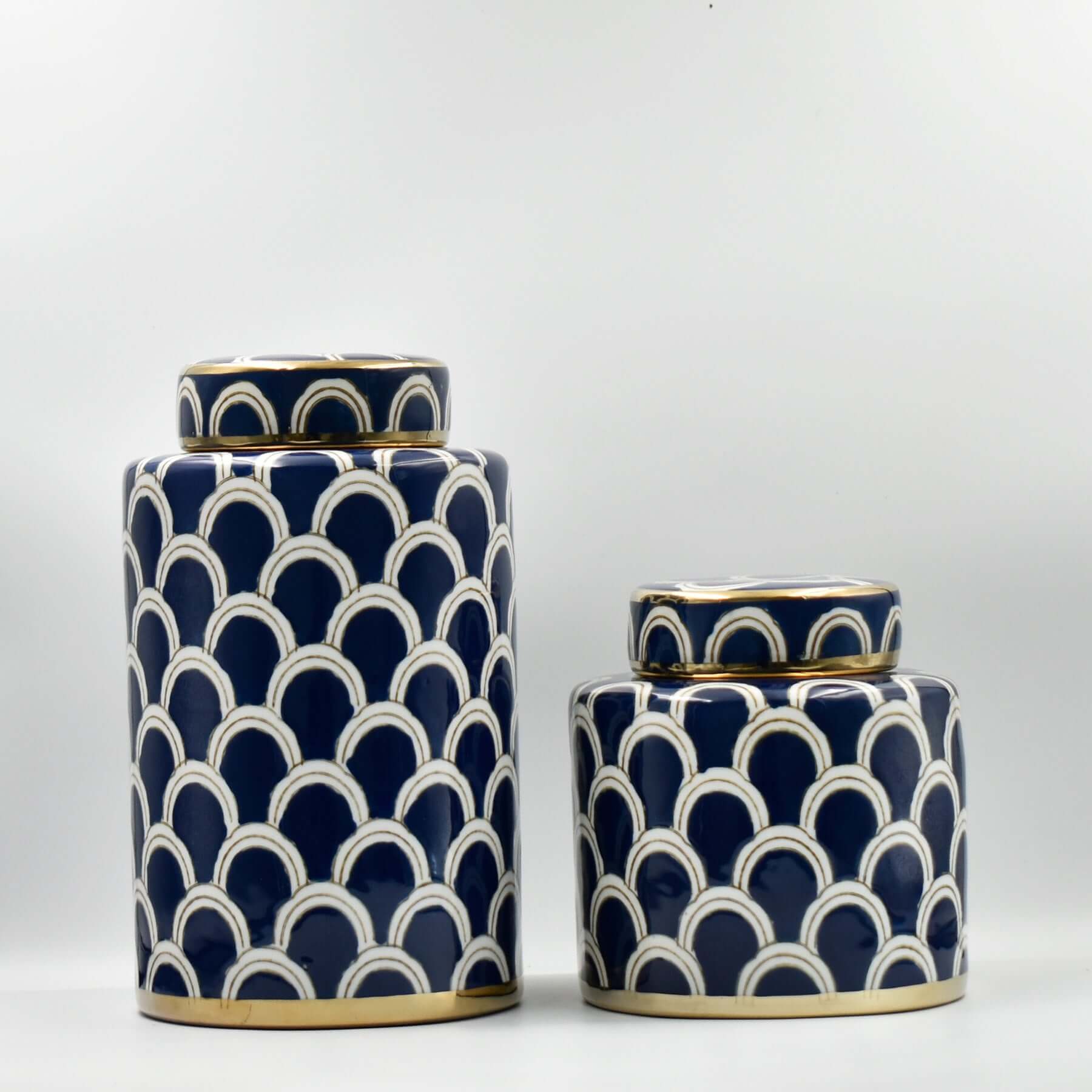 The exquisite Azurean Scallop Ceramic Jar Set is captivating statement home decor and fine ceramic home accents. From Luxury Co, these decorative jars offer impactful interior styling and enhance home ambiance. Perfect as navy and gold scallop ceramic jar