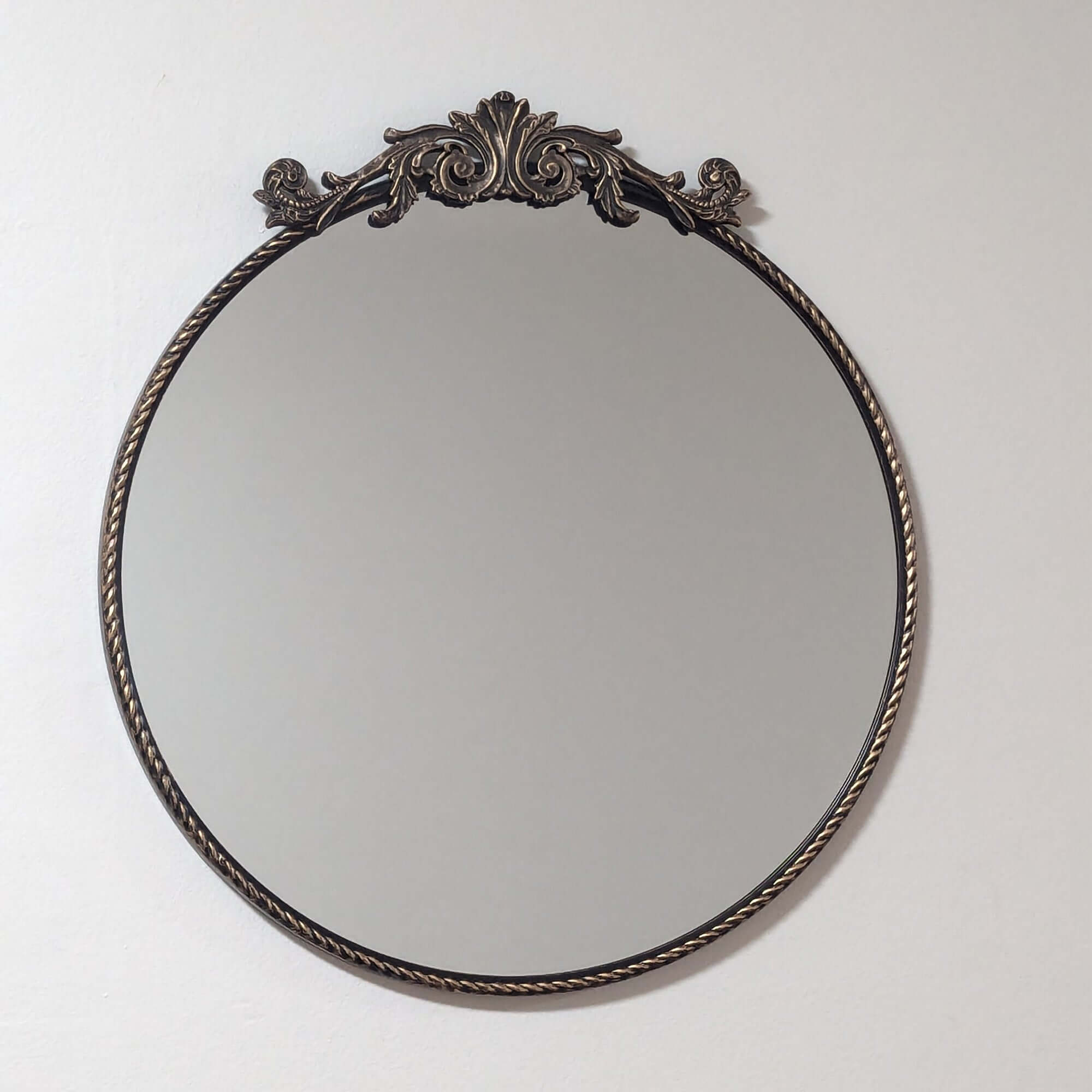 Elevate your space with this Ornate Baroque Round Wall Mirror. Featuring a detailed aged gold frame and intricate motifs, this 60cm circular mirror exudes vintage European elegance and antique charm. Perfect as a decorative accent or statement piece in li