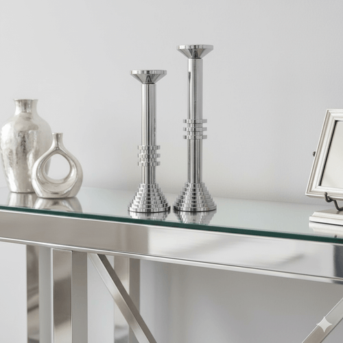 Modern Chrome Sculptural Candle Holder Set displayed on a glass console, emphasizing reflective sophistication and tiered design.