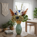 Murano Style Green and Gold Aventurine Tall Vase filled with a colorful floral arrangement in a living room setting.