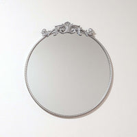 Elevate your space with the Baroque Silver Round Mirror. This 60x60 cm decorative wall mirror features a stunningly ornate silver frame, showcasing classic Baroque style influence. It adds vintage charm and sophistication, perfect as a silver accent mirro