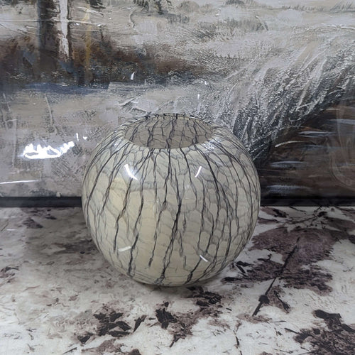 Decorative glass vase with a textured surface on a marble countertop