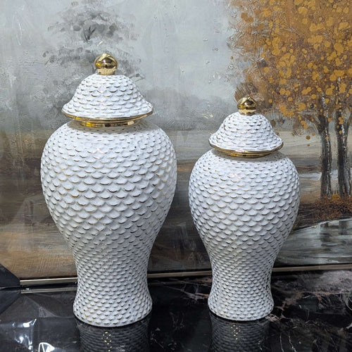 Ginger Jar Set Elegant White & Gold ceramic vases with textured lids, vintage style decor, displayed against a scenic backdrop.