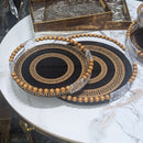 Modern black and gold Greek key serving tray set with beaded handles, perfect for adding sophistication to any home decor.