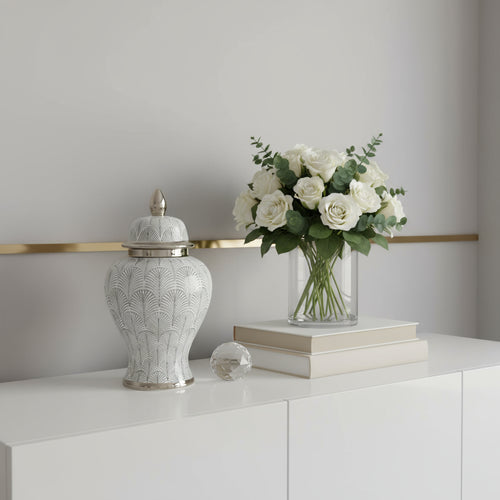 Decorative urns with silver patterns on a marble surface