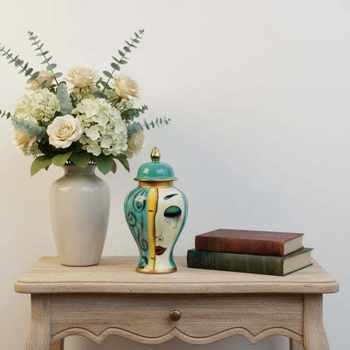 Elevate your interior styling with the Isabella Medium Face Jar, a captivating piece of unique tabletop decor. This exquisite art deco ceramic jar for shelf styling, from Luxury Co, is a unique work of art bringing luxury and personality to your home. Cra